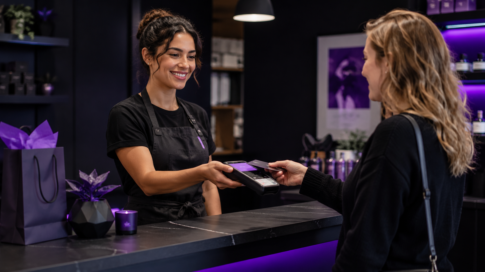 A customer tapping their card to pay at a boutique checkout counter